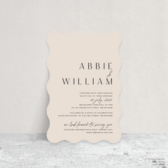 Wave shape flat lay of Abbie wedding invitation with clean, elegant layout and timeless typography, styled with a minimalist aesthetic.