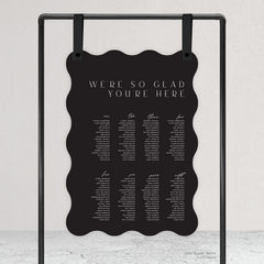 Wave shape flat lay of Abbie wedding seating chart with clean, elegant layout and timeless typography, styled with a minimalist aesthetic.