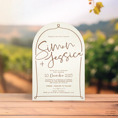 Arch shape flat lay of semi-custom Vino wedding invitation with hand-drawn vineyard-inspired border