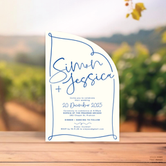 Sail shape flat lay of semi-custom Vino wedding invitation with hand-drawn vineyard-inspired border