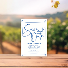 Rectangle shape flat lay of semi-custom Vino wedding save the date with hand-drawn vineyard-inspired border.