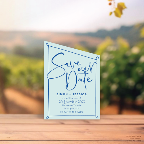 Angle shape flat lay of semi-custom Vino wedding save the date with hand-drawn vineyard-inspired border.