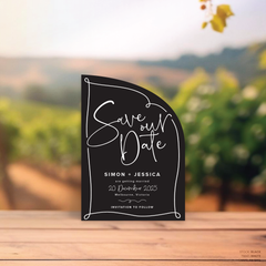 Sail shape flat lay of semi-custom Vino wedding save the date with hand-drawn vineyard-inspired border.