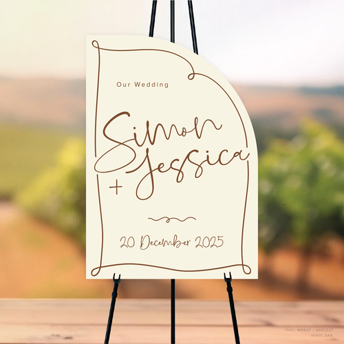 Sail shape flat lay of semi-custom Vino wedding welcome sign with hand-drawn vineyard-inspired border.