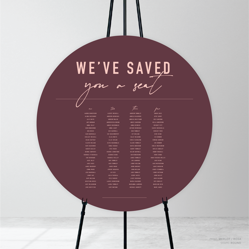 Round shape flat lay of Never Let You Go wedding seating chart featuring bold and delicate typography with modern, expressive layout and semi-custom design.