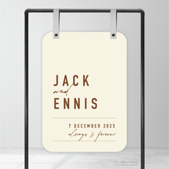 Round corner shape flat lay of Never Let You Go wedding welcome sign featuring bold and delicate typography with modern, expressive layout and semi-custom design.