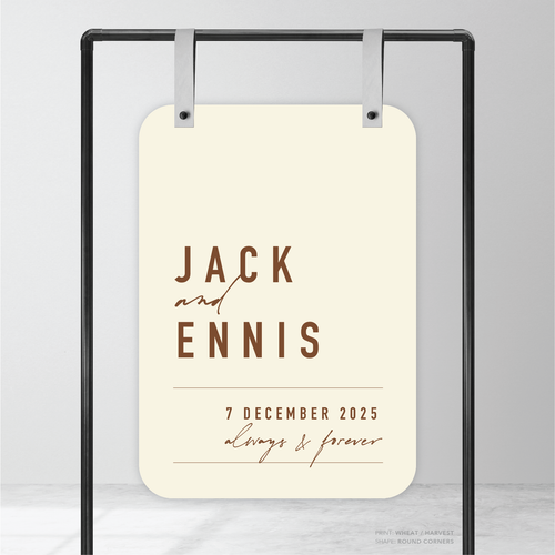 Round corner shape flat lay of Never Let You Go wedding welcome sign featuring bold and delicate typography with modern, expressive layout and semi-custom design.