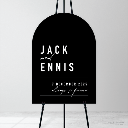 Arch shape flat lay of Never Let You Go wedding welcome sign featuring bold and delicate typography with modern, expressive layout and semi-custom design.